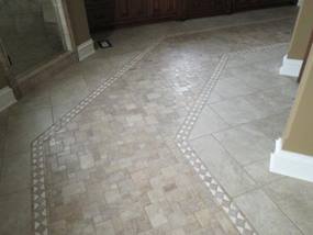 tile flooring in bathroom with stone look tile and geometric pattern tile